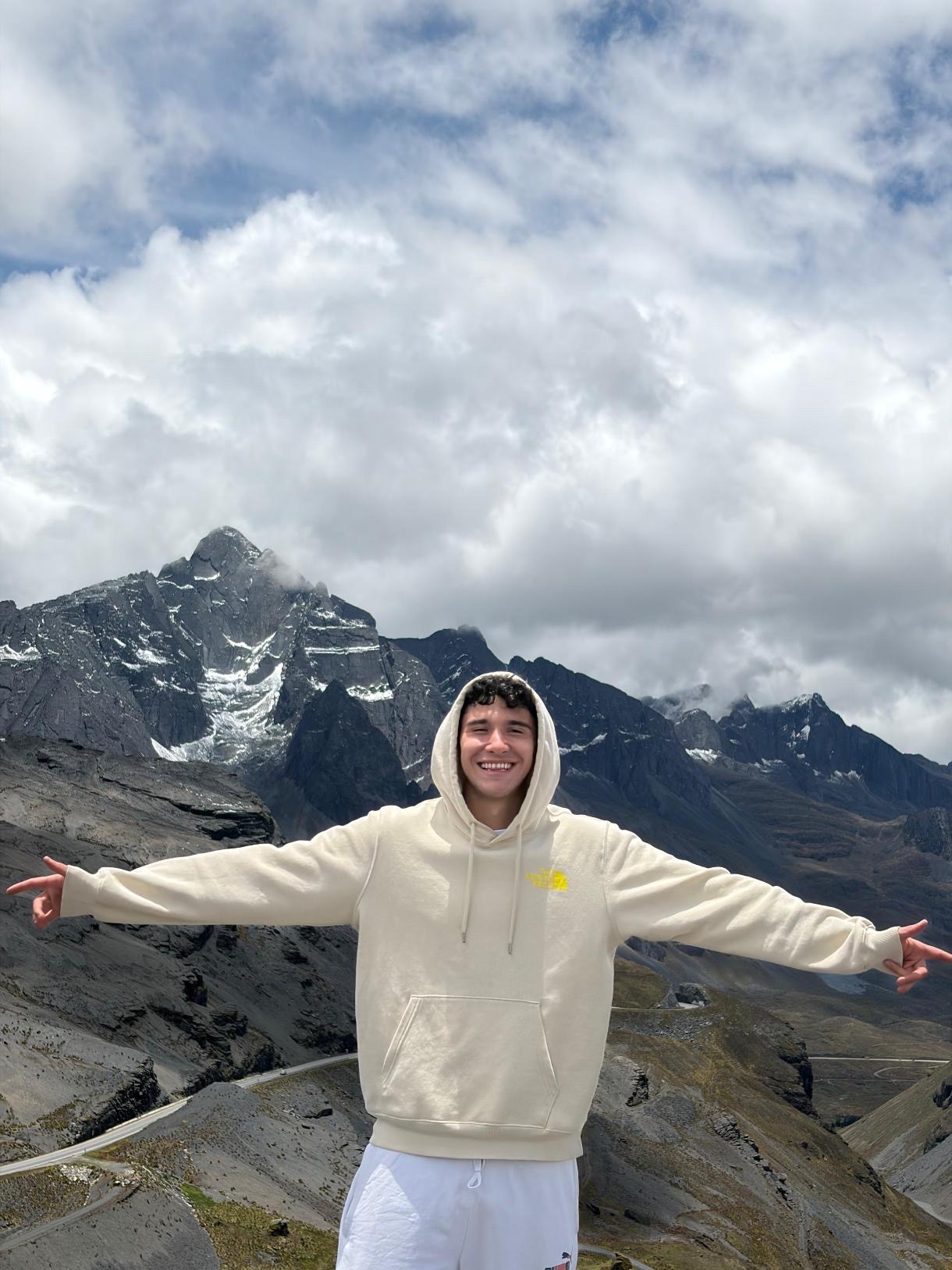 Mateo L. standing in front of the mountains